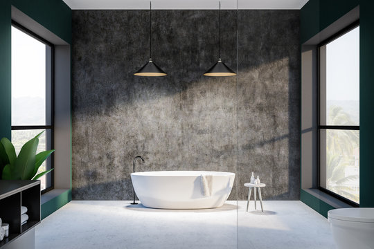 Green and concrete bathroom interior, round tub