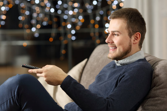 Man watching tv at home in the night