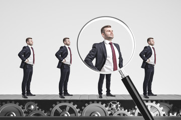 Businessmen on conveyor, magnifying glass