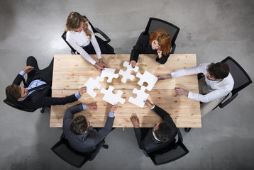 Teamwork of partners. Concept of integration and startup with puzzle pieces