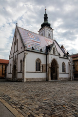 Obraz premium The Church of St. Mark, located in St. Mark's Square in Zagreb, Croatia, originated in the 13th century, reconstructed in the 14th century, featured the Zagreb Coat of arms on the roof.