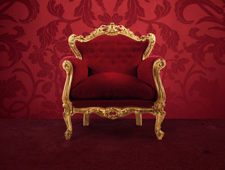 Red and gold luxury armchair into an old room