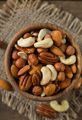 mixed nuts on wooden surface