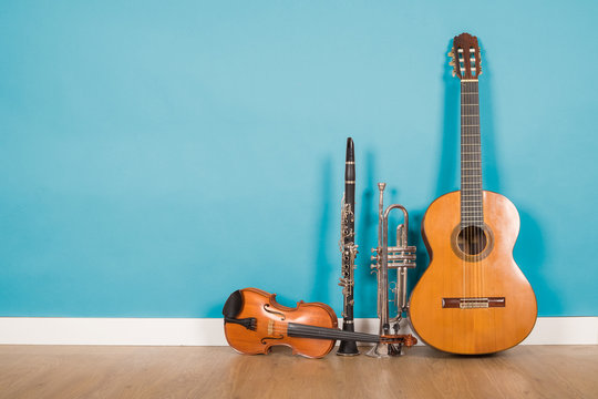 classical guitar, violin, clarinet and trumpet in vintage background