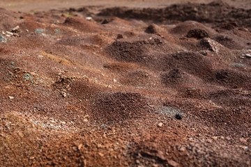 Fototapeta na wymiar Red earth or soil background. Tropical laterite soil background of red clay. Dry Orange surface, Picture of natural disaster. Drought land Caused by global warming and deforestation.