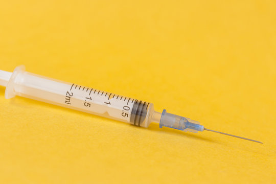 syringe on yellow
