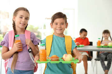 Children with healthy food at school canteen