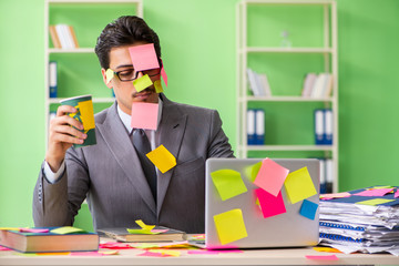 Businessman unhappy with many conflicting priorities sitting in 