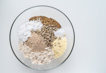 Bowl of gluten free bread dry ingredients on white background