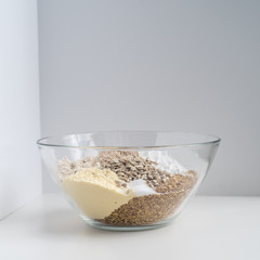 Bowl of gluten free bread dry ingredients on white background