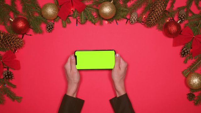 Hands using smartphone on Christmas background