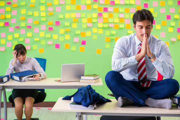 Man and woman in the office with many conflicting priorities in 