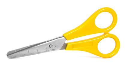 Yellow scissors with ruler isolated on white background