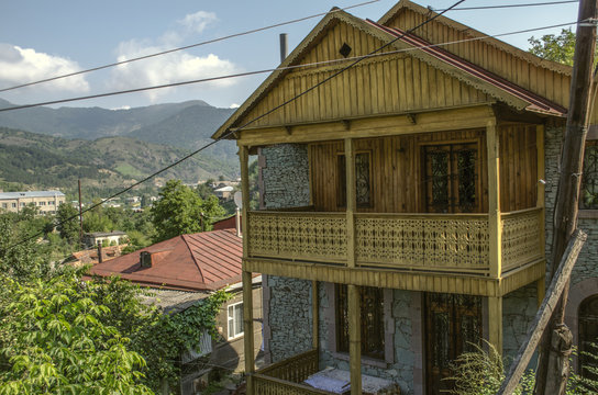 View on the old resort town of Dilijan with wooden balconies and wrought iron gratings among of the mountains,covered with forest