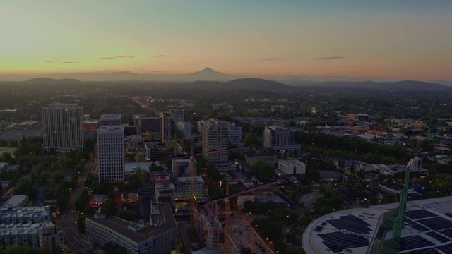 Drone aerial flyover of the Portland  Convention Center at twilight with Mt Hood in the background on a summer day in Portland