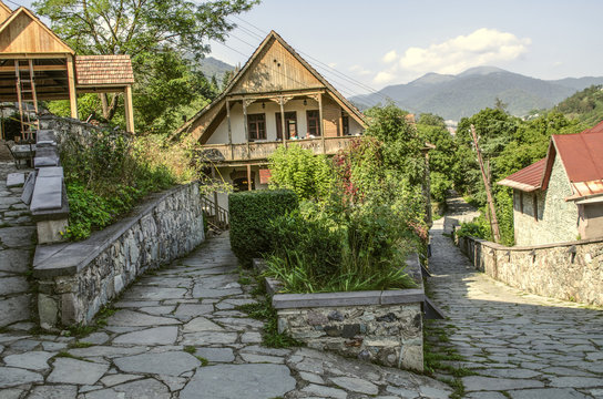 View of the intersecting cobbled streets with old stone houses with wooden balconies and wrought iron bars in the Tufenkian Museum Old Dilijan