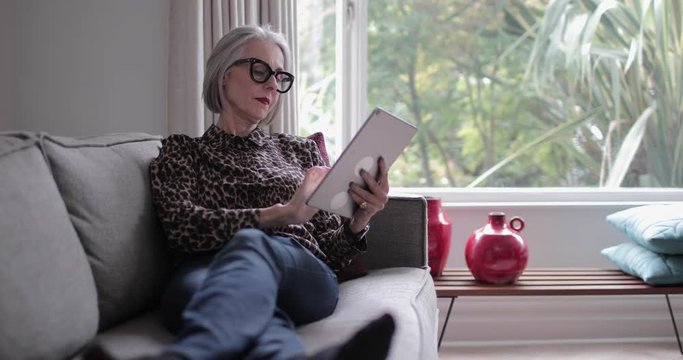Mature adult female using a digital tablet