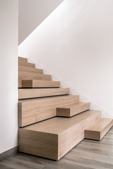 Stylish interior in modern style with wooden stair