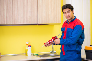 Repairman working in the kitchen 