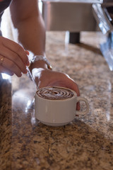 Coffee shop with a girl preparing a coffee cup