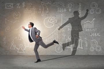 Businessman and his shadow in business concept