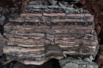 Soil cut-sandstone, stones, clay, sand structure and layers. slice of sand with layers of different structures.
