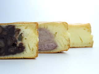 Front view of cream, red beans, and taro-flavored wheel pies ( also called custard pancake)  isolated. Wheel pies is a popular snack in Taiwan. Taiwanese food concept. Dessert time.