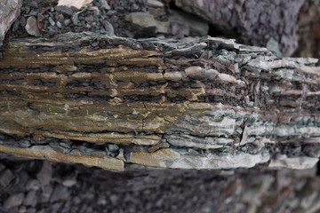 Soil cut-sandstone, stones, clay, sand structure and layers. slice of sand with layers of different structures.