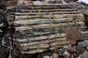 Soil cut-sandstone, stones, clay, sand structure and layers. slice of sand with layers of different structures.