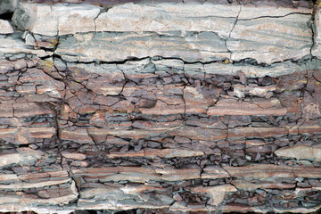 Soil cut-sandstone, stones, clay, sand structure and layers. slice of sand with layers of different structures.