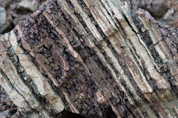 Soil cut-sandstone, stones, clay, sand structure and layers. slice of sand with layers of different structures.