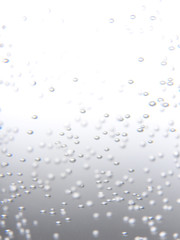 Many transparent circular bubbles float  in sweet soda drink. Carbonated drink is liquid beverage.  Summer cool and fresh concept. With copy space. Abstract background.