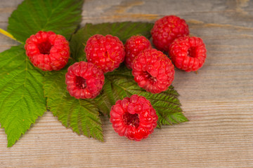 sweet juicy raspberry on green leaf