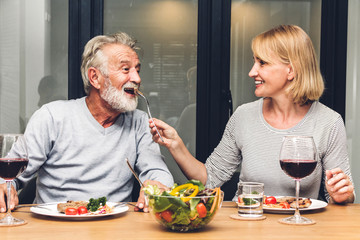 Senior couple enjoy eating  healthy breakfast together in the kitchen.Retirement couple concept - Powered by Adobe