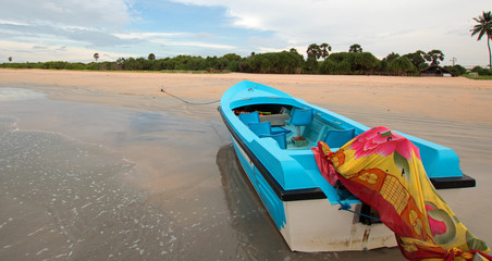 Boat on tropical beach Nilaveli beach in Sri Lanka Asia