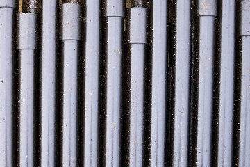Obraz premium Drilling of oil and gas wells. Drill pipe inspection. Tubing for oil and gas listed on the pedestal out of the wells after washing and ready for inspection. Stack of casing laying on the deck