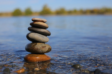 Fototapeta na wymiar Meditation in nature including a cairn of stones