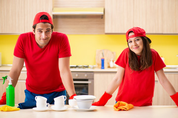 Cleaning professional contractors working at kitchen