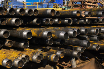 Drilling of oil and gas wells. Drill pipe inspection. Tubing for oil and gas listed on the pedestal out of the wells after washing and ready for inspection. Stack of casing laying on the deck