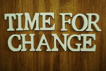 time for change alphabet letters top view on wooden background