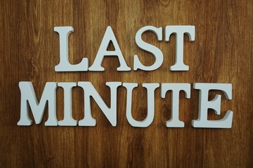 last minute alphabet letters top view on wooden background