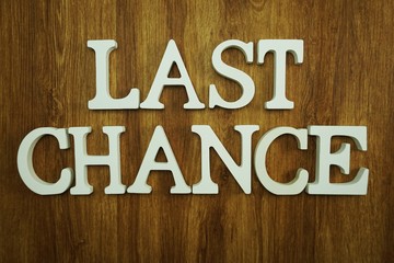 last chance alphabet letters top view on wooden background