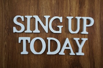 sing up today alphabet letters top view on wooden background