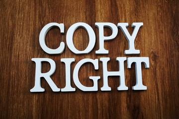 copy right alphabet letters top view on wooden background