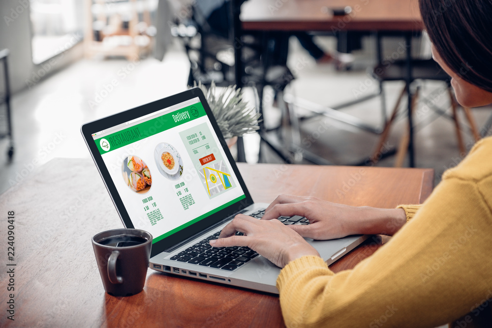 Aufkleber close up woman sitting and orde food online on laptop computer in add to cart function webpage at co