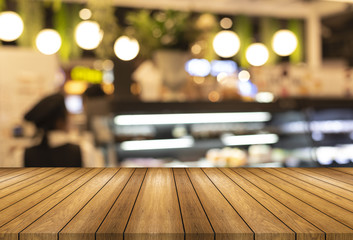 Wooden board empty table and blurred or defocus background and light bulb bokeh . Perspective brown...