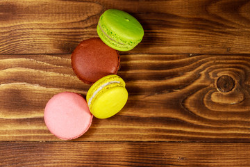 Tasty colorful macaroons on wooden table