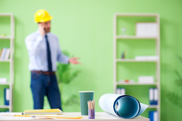 Young male architect working at the project