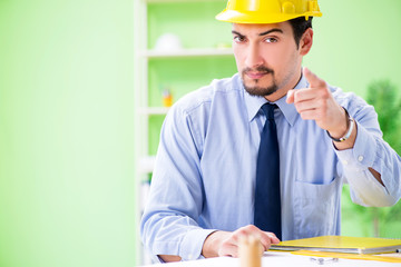 Young male architect working at the project