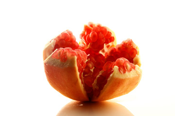 Pomegranate fruit on white background / Pomegranate juice contains higher levels of antioxidants than most other fruit juices